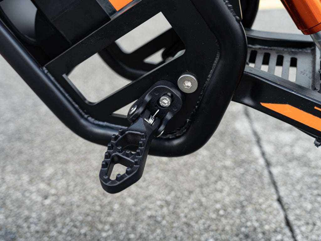 GT54 Electric Mini Motorbike black metal foldable footpeg and frame detail with orange accents