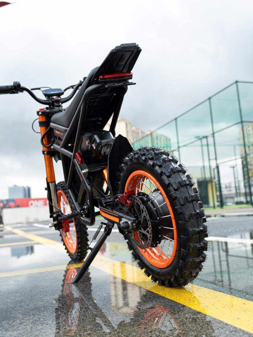 GT54 Electric Mini Motorbike featuring black and orange frame, knobby off-road tires, and robust rear motor assembly for powerful performance