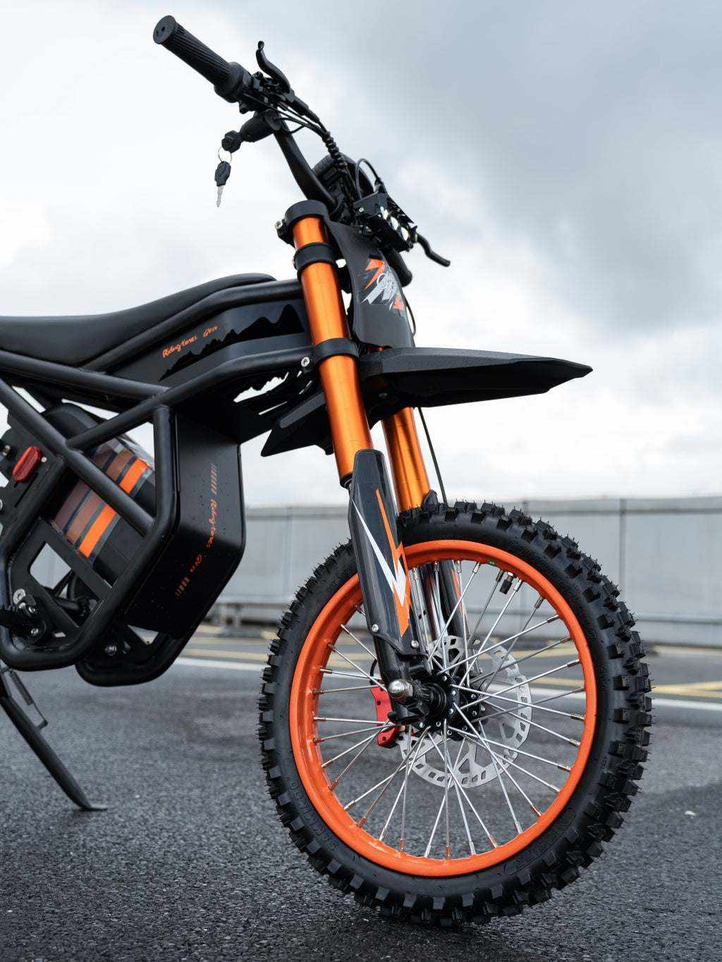 GT54 Electric Mini Motorbike with black frame, orange suspension forks, and knobby tires for off-road durability and performance