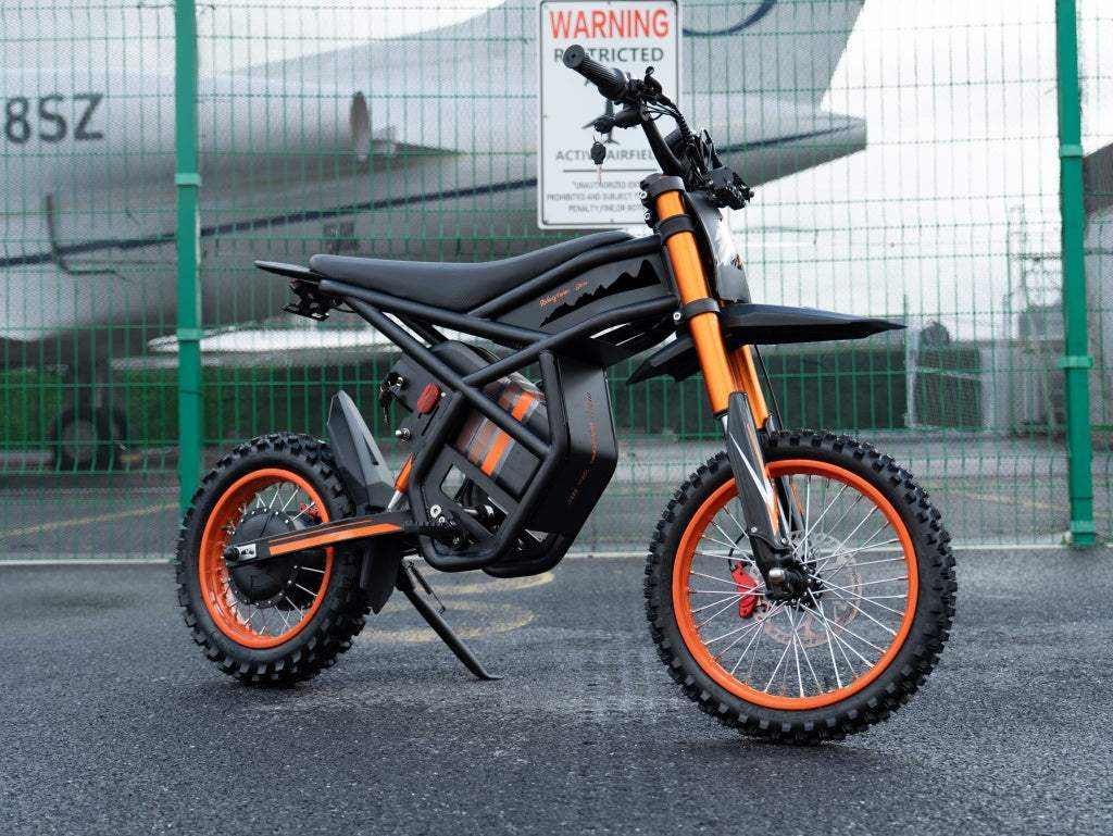 GT54 Electric Mini Motorbike in black with orange accents, knobby tires, and rugged off-road design for teens and adults