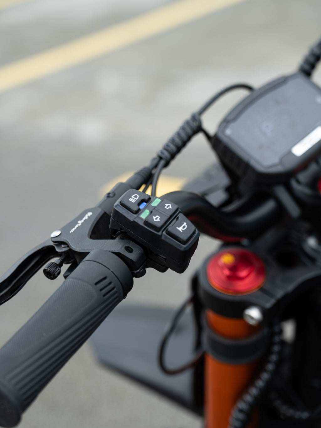 GT54 Electric Mini Motorbike black handlebar grip with control buttons and brake lever on an orange frame