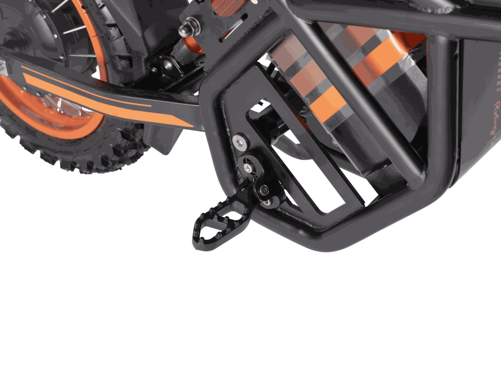 GT54 Electric Mini Motorbike close-up showing black metal frame, orange wheel rim, rugged tire, and foot peg detail