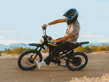 Jasion Patrol 52 electric dirt bike in black and yellow with rider wearing black helmet, featuring knobby tires and suspension