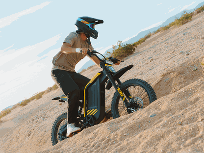 Jasion Patrol 52 electric dirt bike in black and yellow with rugged motorcycle-grade tires and full suspension, ridden on sandy terrain