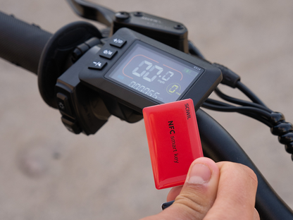 Jasion Patrol 52 electric dirt bike featuring a black handlebar with a digital full-color display and a red NFC smart key for keyless start system
