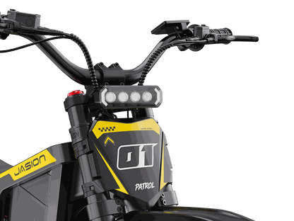 Jasion Patrol 52 electric dirt bike front view with black and yellow frame, LED headlight, and rugged handlebars