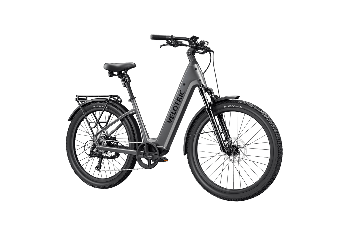 Velotric Discover 3 electric bike in matte gray with step-thru frame, black saddle, suspension fork, and thick tires