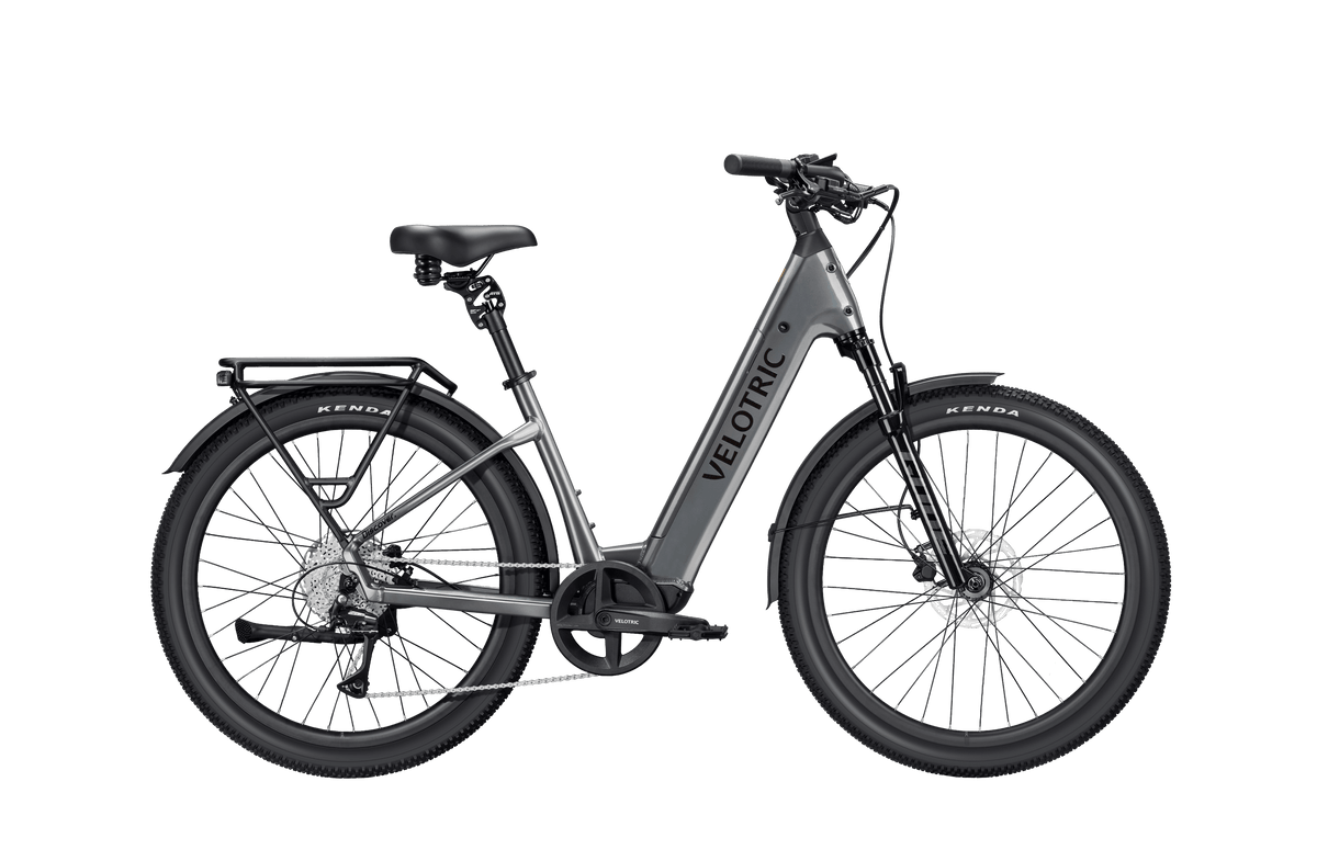 Velotric Discover 3 electric bike in matte gray with black accents, step-through frame, front suspension, and rear rack