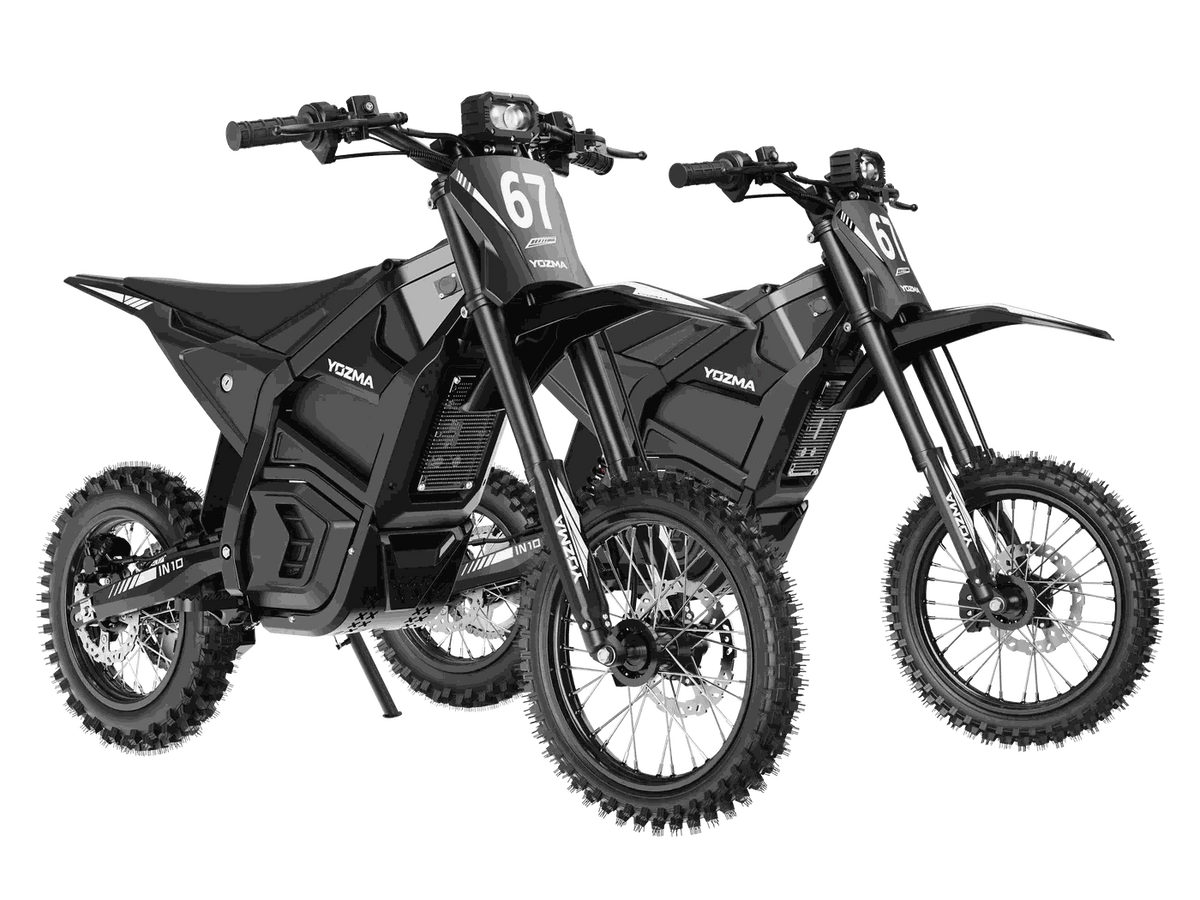 Two black Yozma IN-10 Electric Dirt Bikes with knobby off-road tires, reinforced steel frames, and front suspension forks, featuring number 67 on the front.